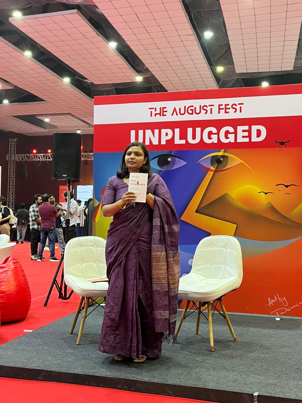 Alisha speaking at The August Fest Unplugged
